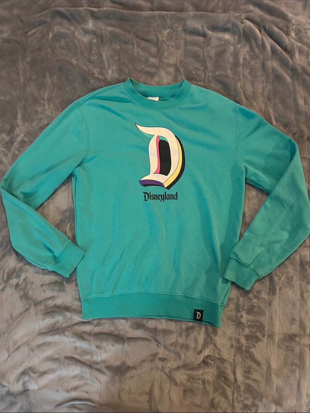 Disney unisex Teal Crewneck Sweatshirt with Multicolor D Logo